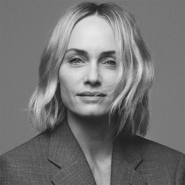 Amber Valletta, A black and white image of a white woman with light, chin-length hair. She is wearing a dark blazer.