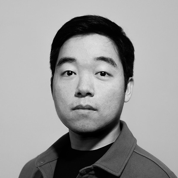 Seung Won Baik, A black and white image of an Asian man with shirt dark hair, wearing a collared shirt.