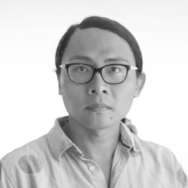 Tom Chi, an Asian man with hair pulled back