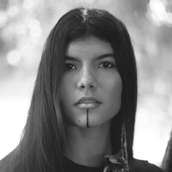 Zaya Ribeiro, a young Indigenous Brazilian woman with long black hair, and a vertical line tattooed from the edge of her bottom lip down to her chin